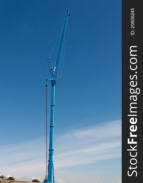A bungee jumper jumping from a giant crane. A bungee jumper jumping from a giant crane