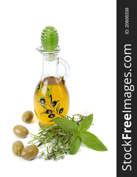 Oil in bottle and herbs on white background. Oil in bottle and herbs on white background