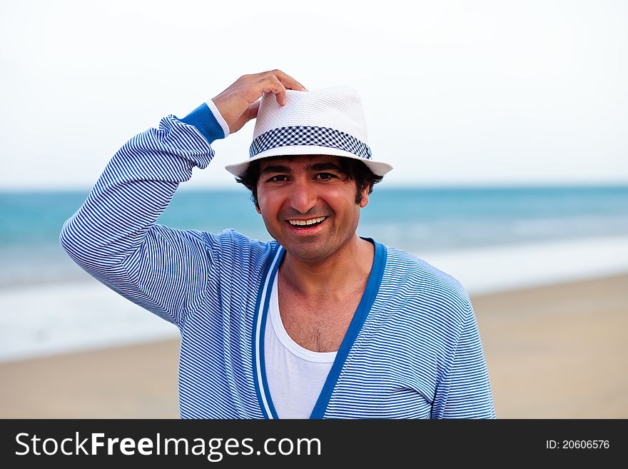Happy man holding a hat and smiling. Happy man holding a hat and smiling
