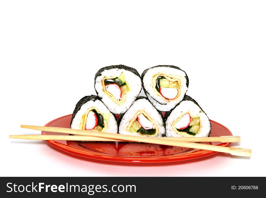 Traditional Japanese sushi on a red plate, isolated on white background. Traditional Japanese sushi on a red plate, isolated on white background