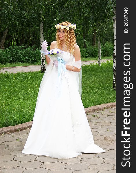 Bride posing outdoors in a park. Bride posing outdoors in a park