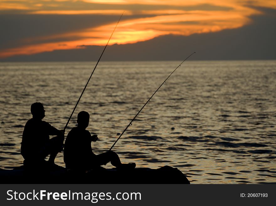 Fisherman fishing at beautiful sunset. Fisherman fishing at beautiful sunset