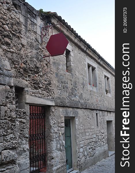 A medieval village with a ruined castle set on a hilltop in the Alpilles mountains. Old castle with iron gate. A medieval village with a ruined castle set on a hilltop in the Alpilles mountains. Old castle with iron gate