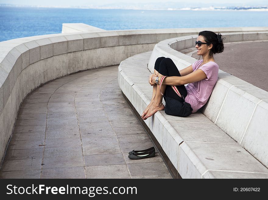 Woman relaxing in front of the beach on holidays. Woman relaxing in front of the beach on holidays