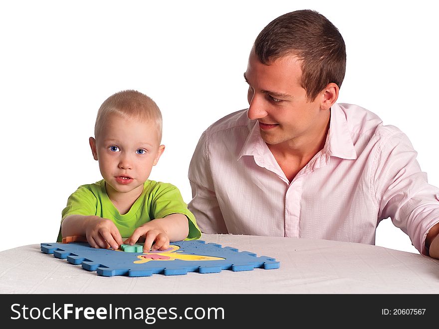 Smart dad and his son play at table. Smart dad and his son play at table