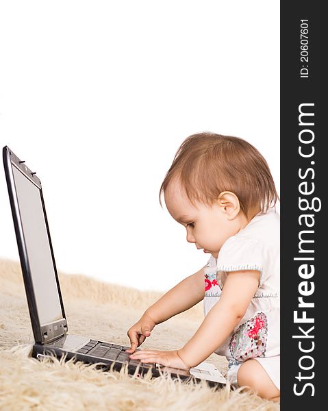 Cute little girl with laptop on capet