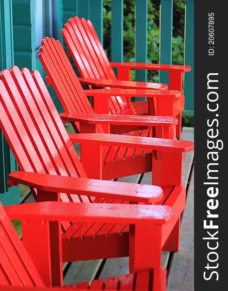 Red wooden adenak chairs with a turquoise background. Red wooden adenak chairs with a turquoise background
