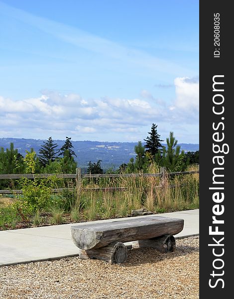 Long seat made out of an old weathered tree trunk overlooking a valley view in Oregon. Long seat made out of an old weathered tree trunk overlooking a valley view in Oregon.