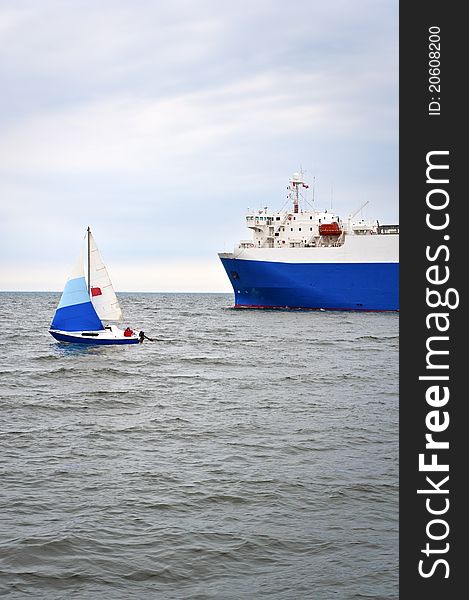 Yacht and trade ship on the sea