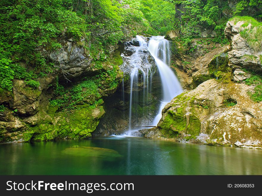 Beautiful waterfall falling into peaceful river