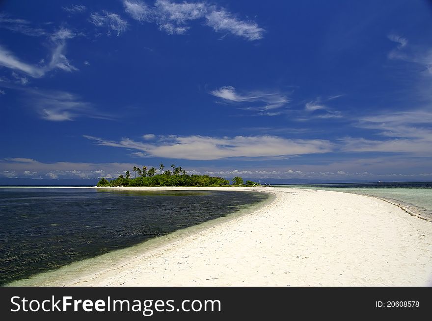 Narrow sand strip leading to isolated tropical island. Narrow sand strip leading to isolated tropical island