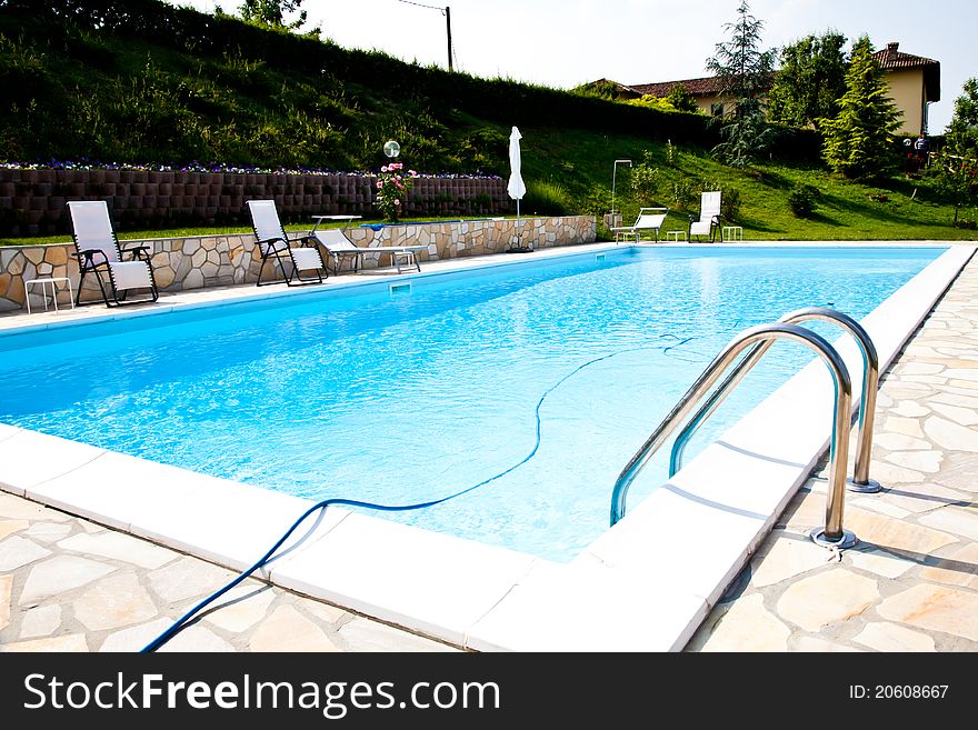 Swimming pool of an Italian beauty farm in the middle vineyards, Monferrato area, Piemonte region. Swimming pool of an Italian beauty farm in the middle vineyards, Monferrato area, Piemonte region.