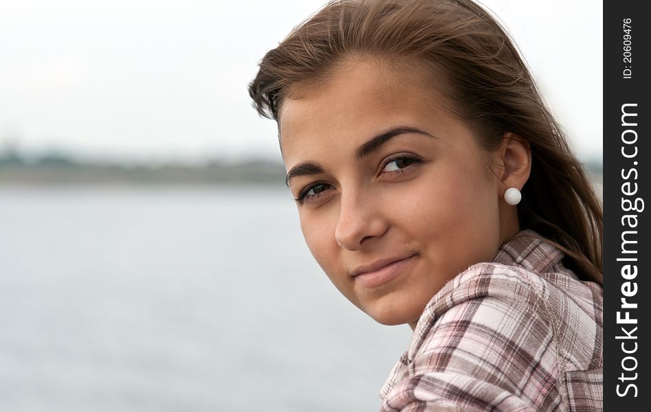 Portrait of a beautiful girl on the background of the horizon