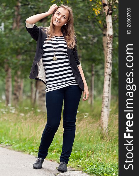 Beautiful girl on a background of birch trees