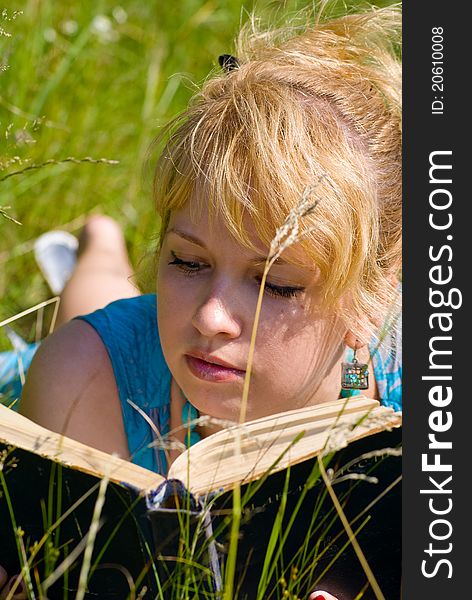 Girl in grass with book