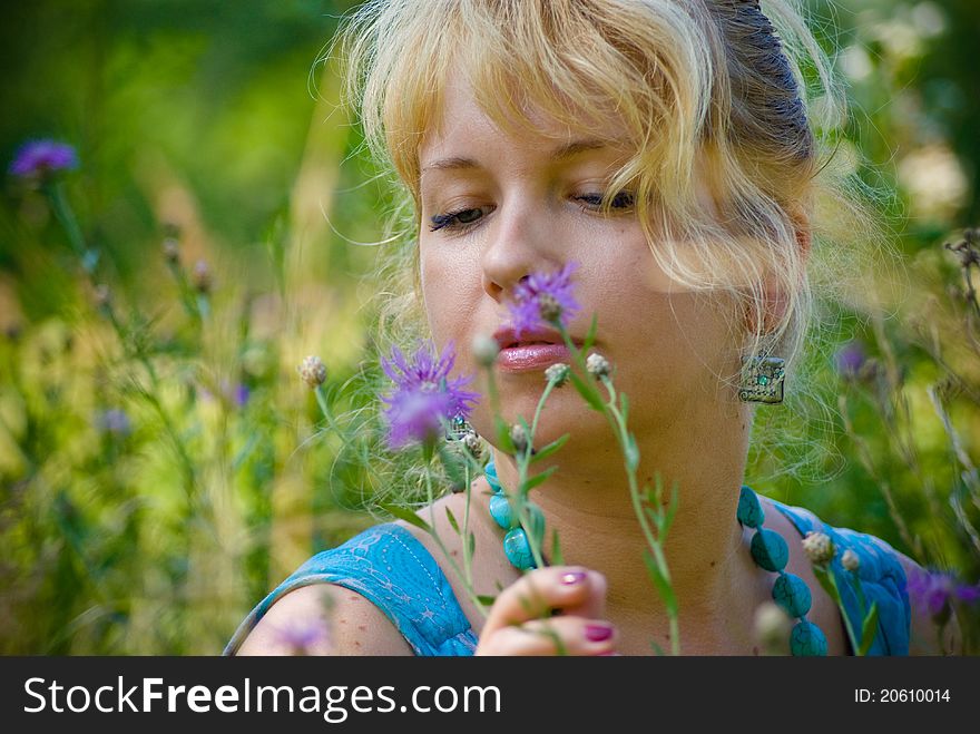 Woman in grass with violet flowers