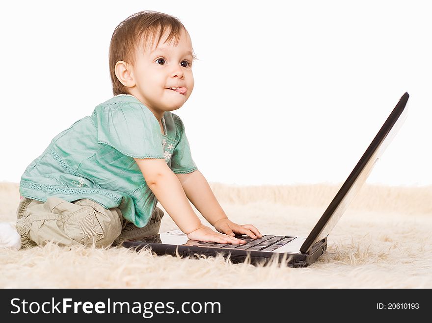 Cute little girl with laptop on capet. Cute little girl with laptop on capet