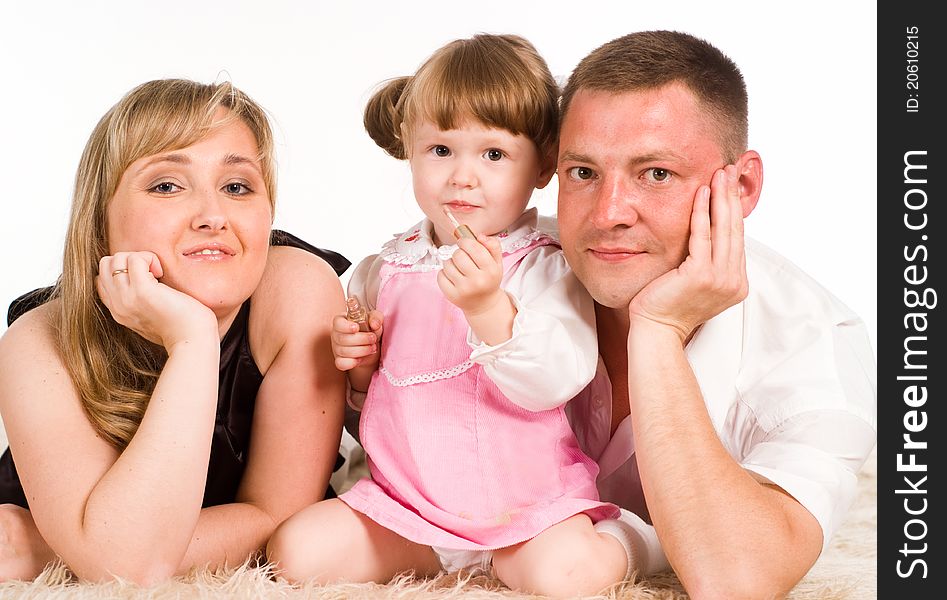 Nice family of a three playing on a carpet. Nice family of a three playing on a carpet