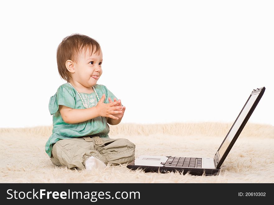 Cute little girl with laptop on capet. Cute little girl with laptop on capet