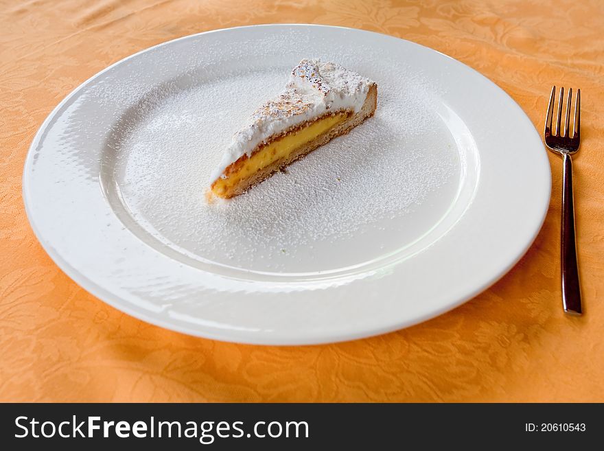 Lemon cake on white plate in restaurant