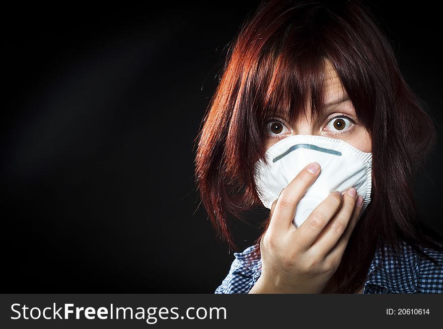 Girl wearing protective mask on black background