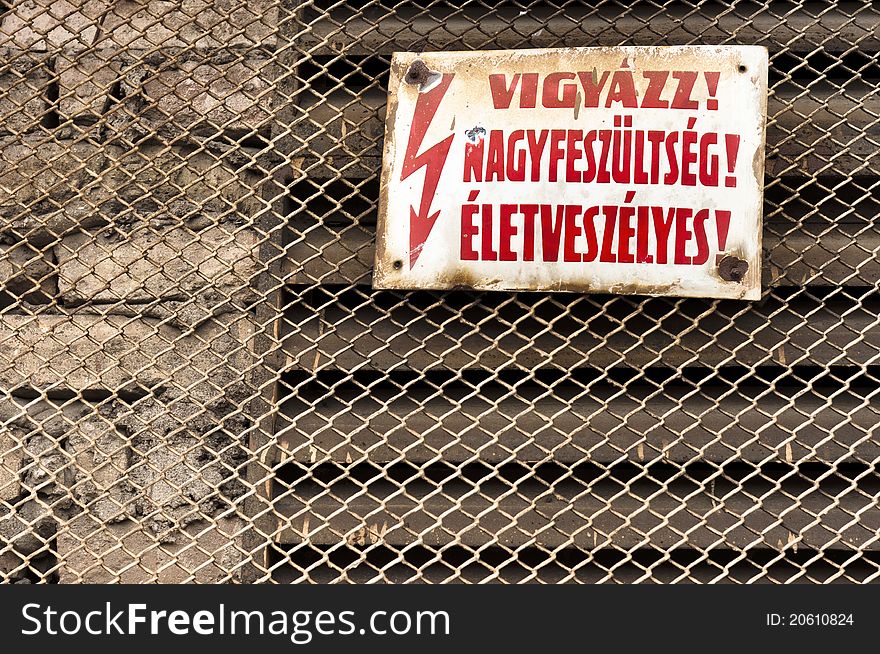 Danger! High voltage sign on metal fence