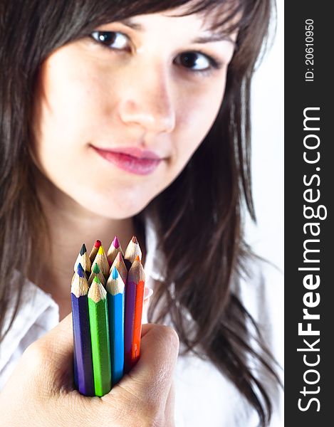 Student girl with colored pencils and selective focus