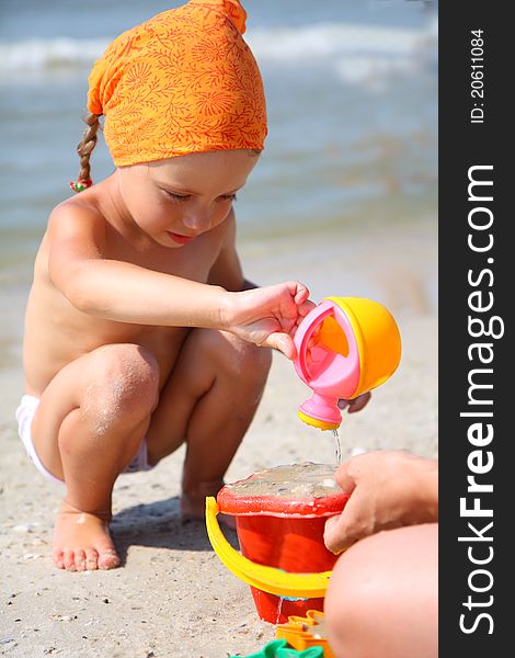 Cute Girl Playing With Beach Toys