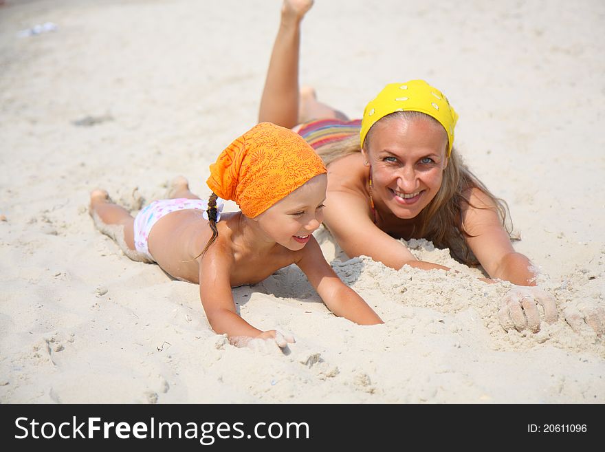 Little girl and her mother at the beach. Little girl and her mother at the beach