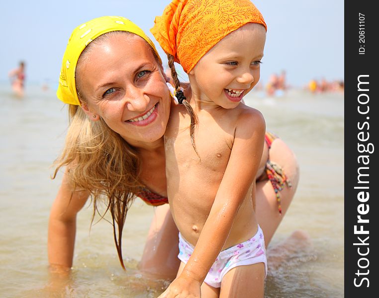 Little girl with her mother at the beach