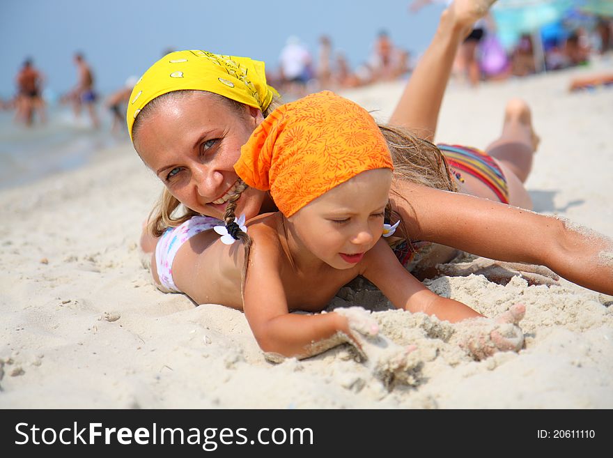 Little a girl with her mother at the beach
