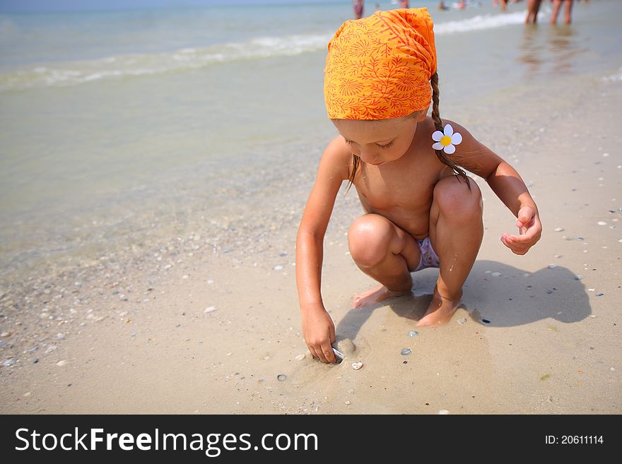 Cute girl playing with beach toys