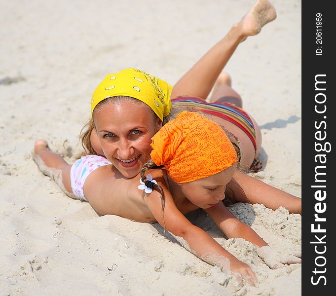 Little a girl with her mother at the beach