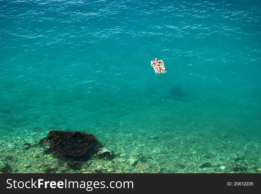 Girl sunbathing on adriatic waters in croatia