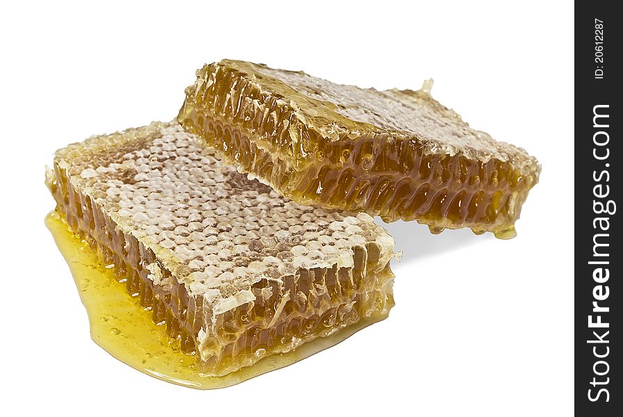 Two pieces of honey comb on a white background