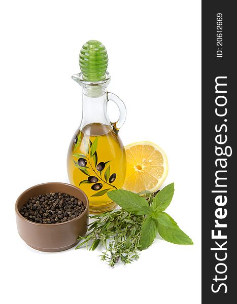 Oil in bottle and herbs on white background. Oil in bottle and herbs on white background