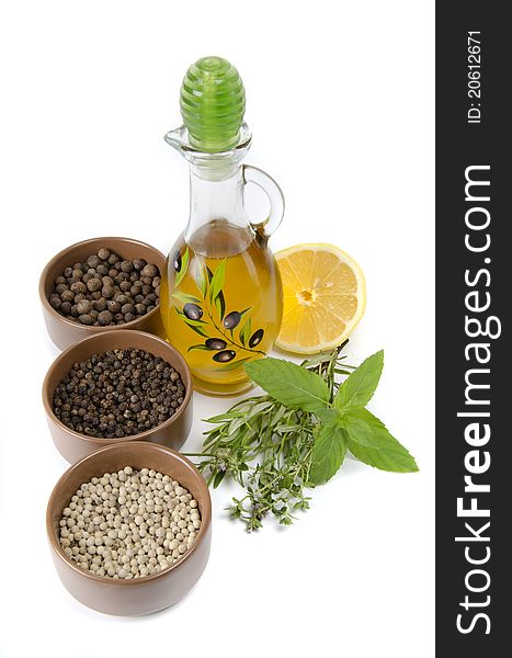 Oil in bottle and herbs on white background. Oil in bottle and herbs on white background