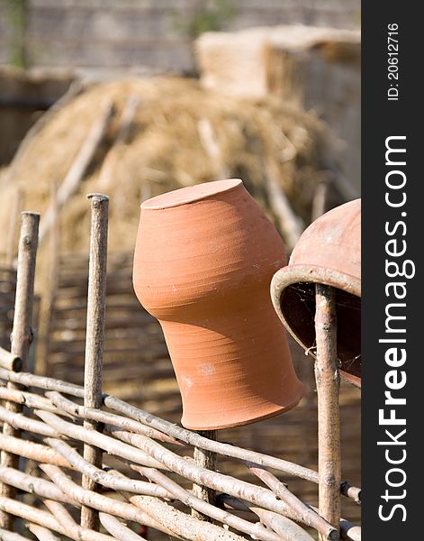 Clay jugs on fence. Outdoor