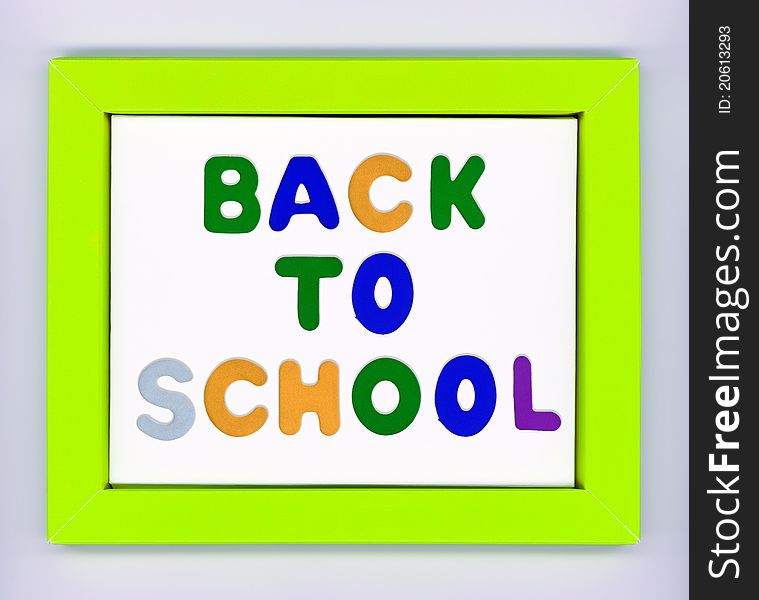 Green paper frame with words Back to school on white background