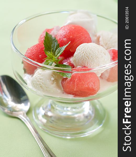 Watermelon and lemon sorbet with mint in glass bowl. Selective focus. Watermelon and lemon sorbet with mint in glass bowl. Selective focus