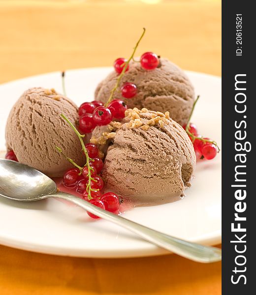 Ice cream with red currant topping. Selective focus