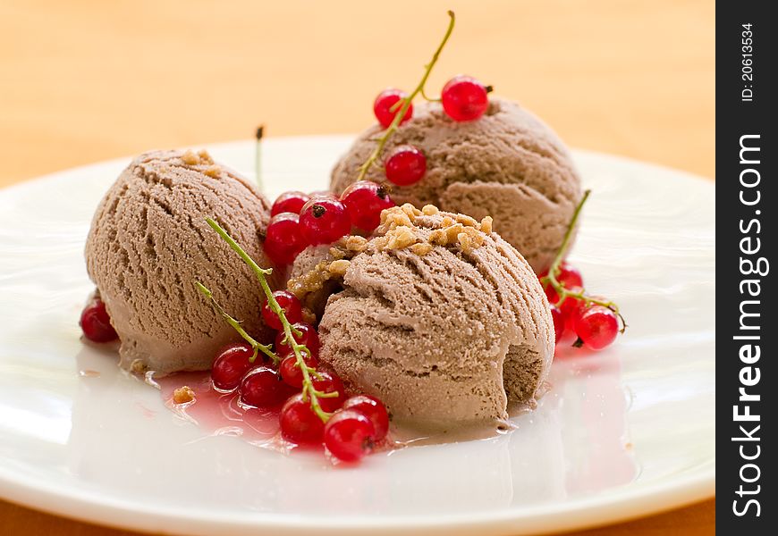 Chocolate Ice cream with red currant  topping. Selective focus