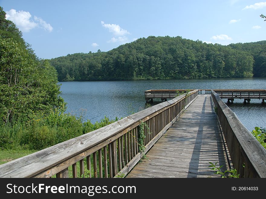 A view of a dock on a lake in the mountains during the summer. A view of a dock on a lake in the mountains during the summer