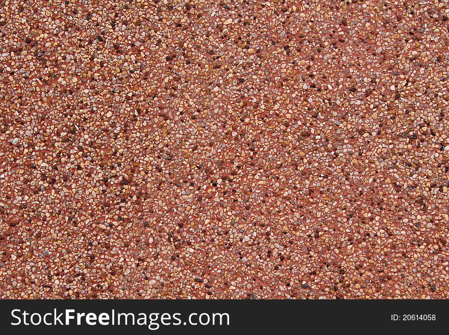 Walls built with multi-colored sand on a red background.