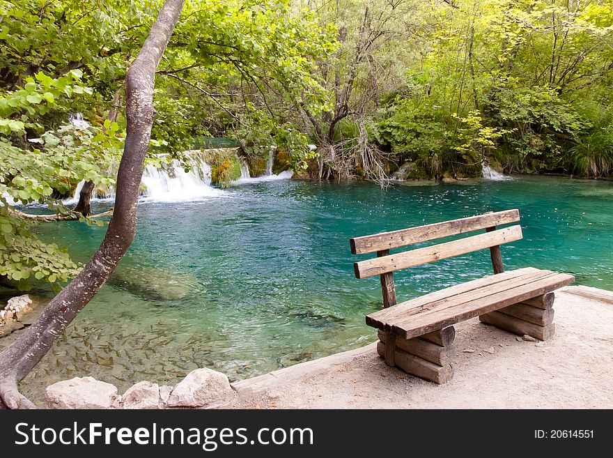 Small wooden bench in plitvice lake coratia.