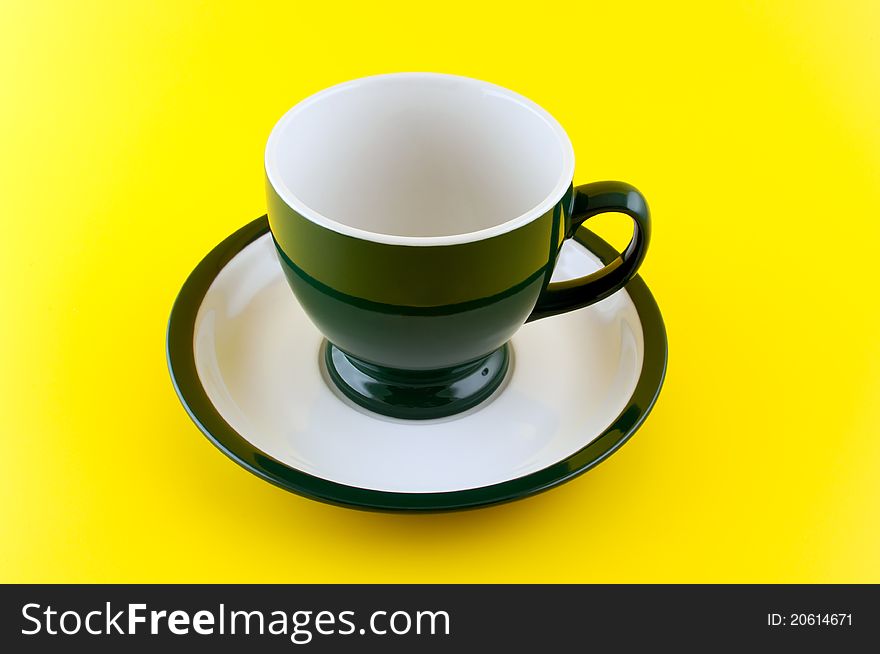 Empty Cup On Yellow Background.