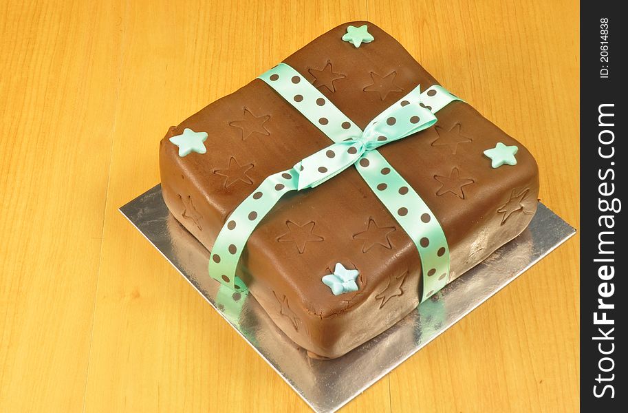 A delicious looking chocolate cake with a
ribbon tied around