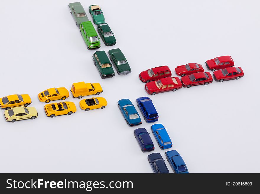 A cross of red, blue, yellow and green cars. A cross of red, blue, yellow and green cars