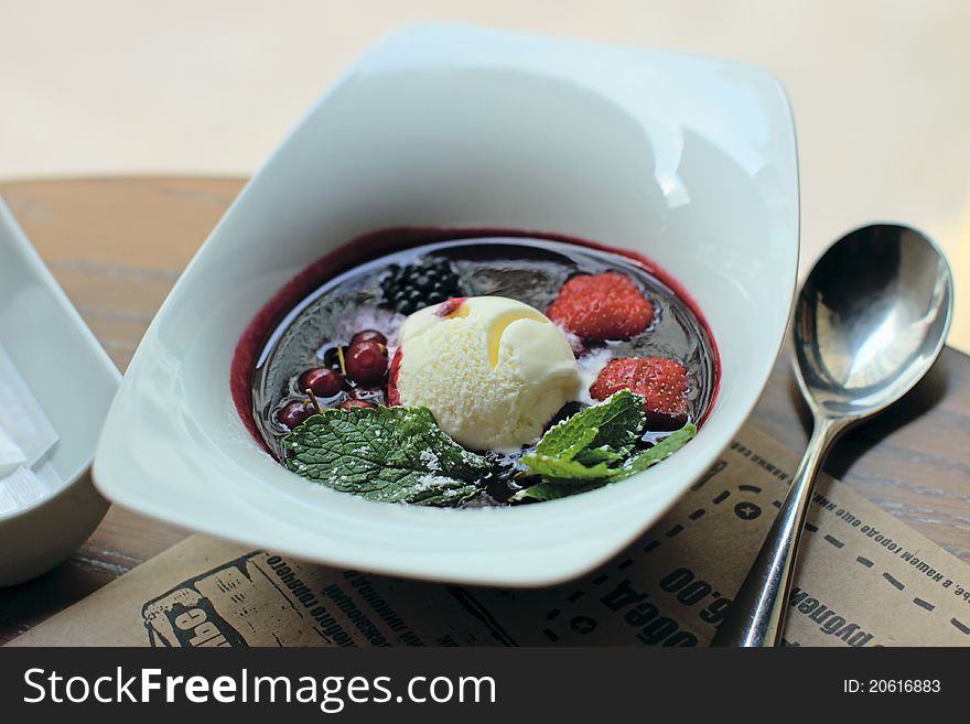 A bowl of chilled berries soup, garnished with a vanilla ice-cream and a fresh sprig of mint. A bowl of chilled berries soup, garnished with a vanilla ice-cream and a fresh sprig of mint.