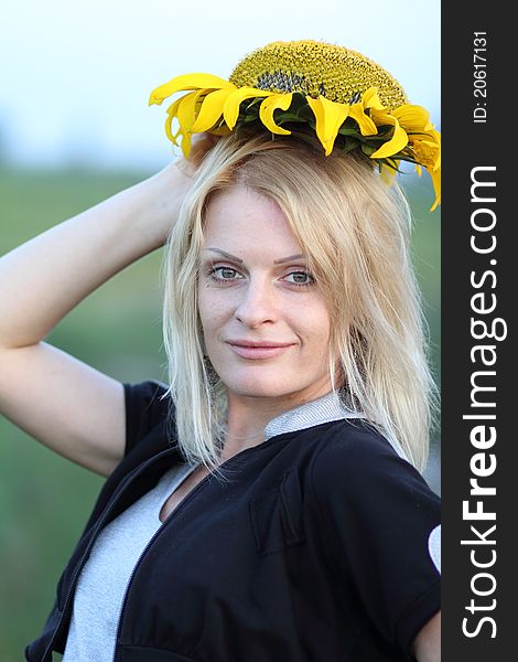 Beauty woman and sunflowers on field